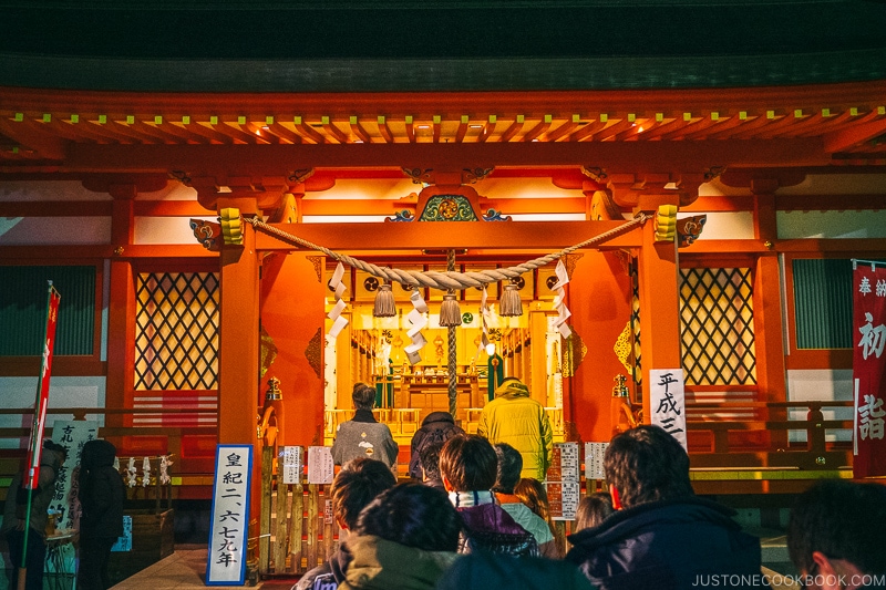 A group of people standing in front of a shrine