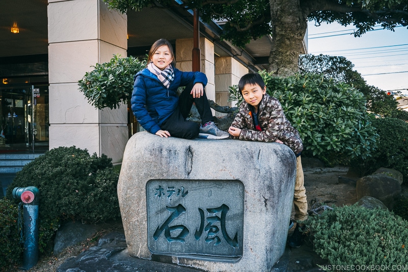 children next to Hotel Sekifu sign - Celebrate New Year at Isawa Onsen in Yamanishi | www.justonecookbook.com 