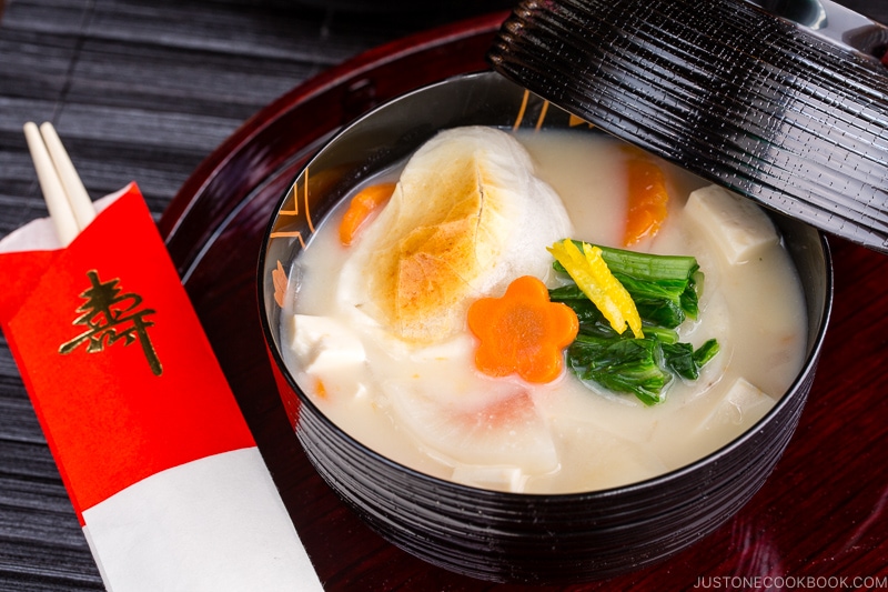 A black and gold lacquered bowl containing Japanese New Year Soup Ozoni.