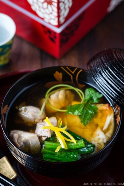 A black and gold lacquered bowl containing Japanese New Year Soup Ozoni.