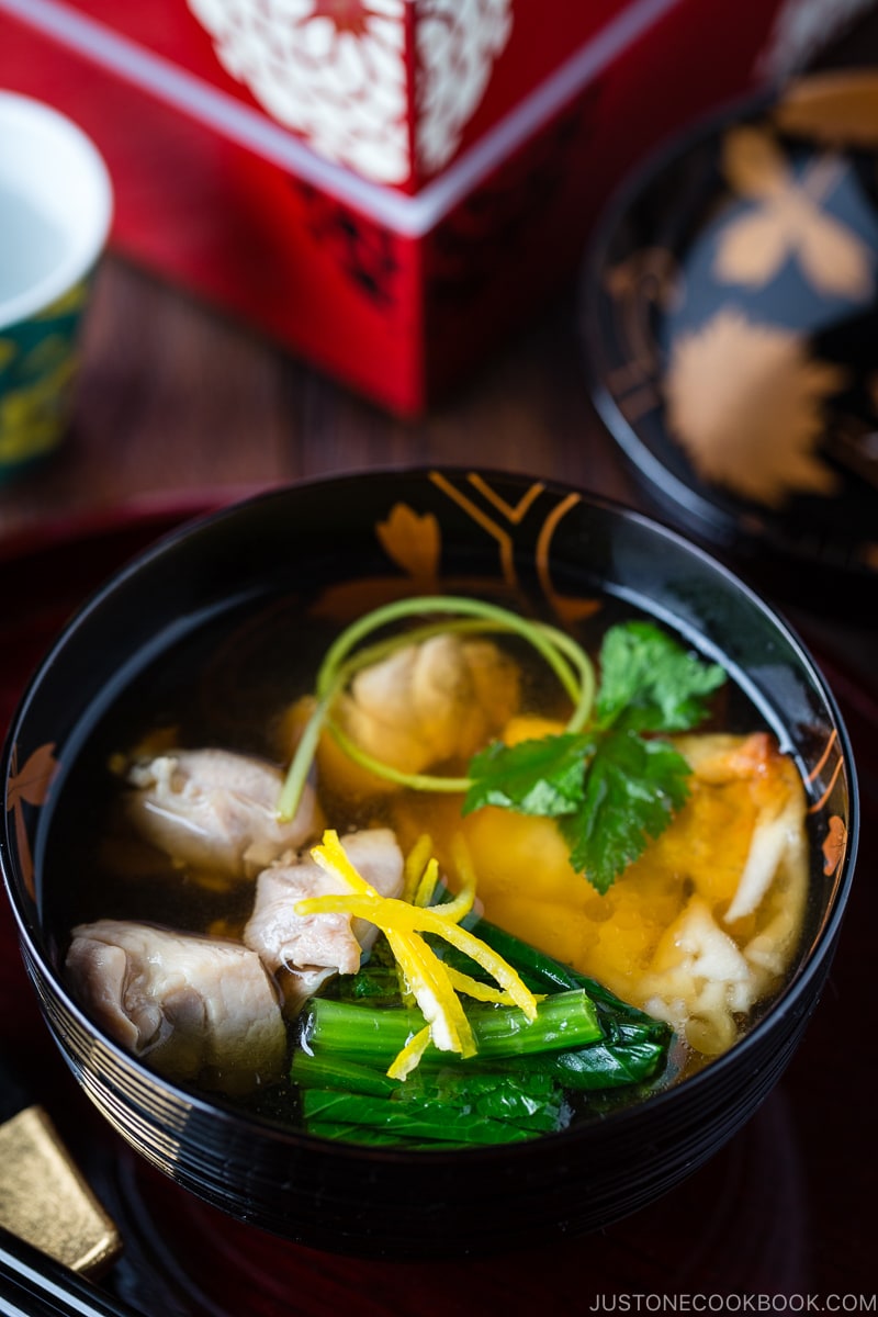 A black and gold lacquered bowl containing Japanese New Year Soup Ozoni.