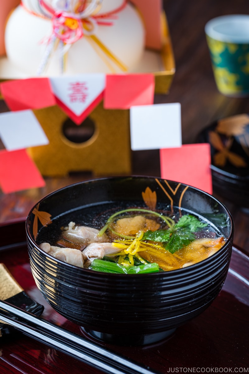 A black and gold lacquered bowl containing Japanese New Year Soup Ozoni.