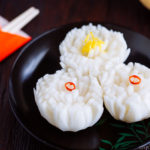 A black lacquered plate containing Pickled Chrysanthemum Turnip (Kikka Kabu).