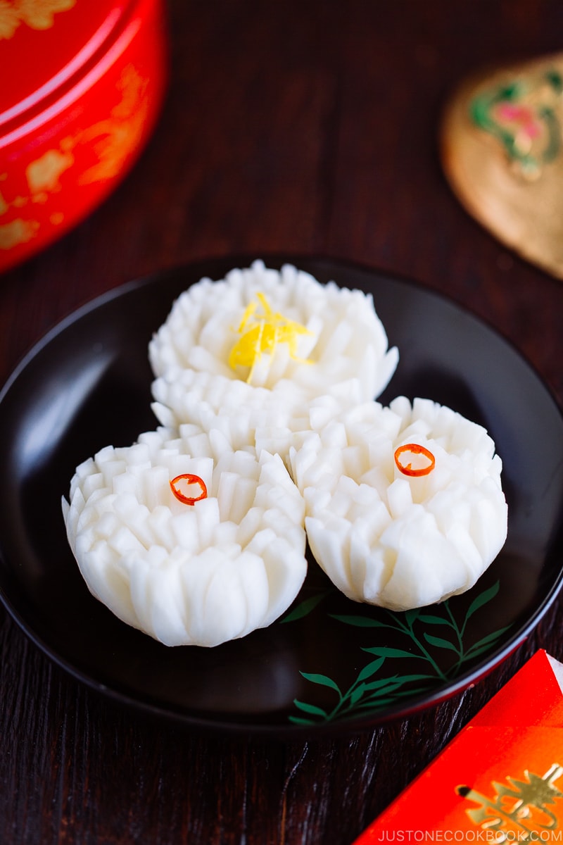 A black lacquered plate containing Pickled Chrysanthemum Turnip (Kikka Kabu).