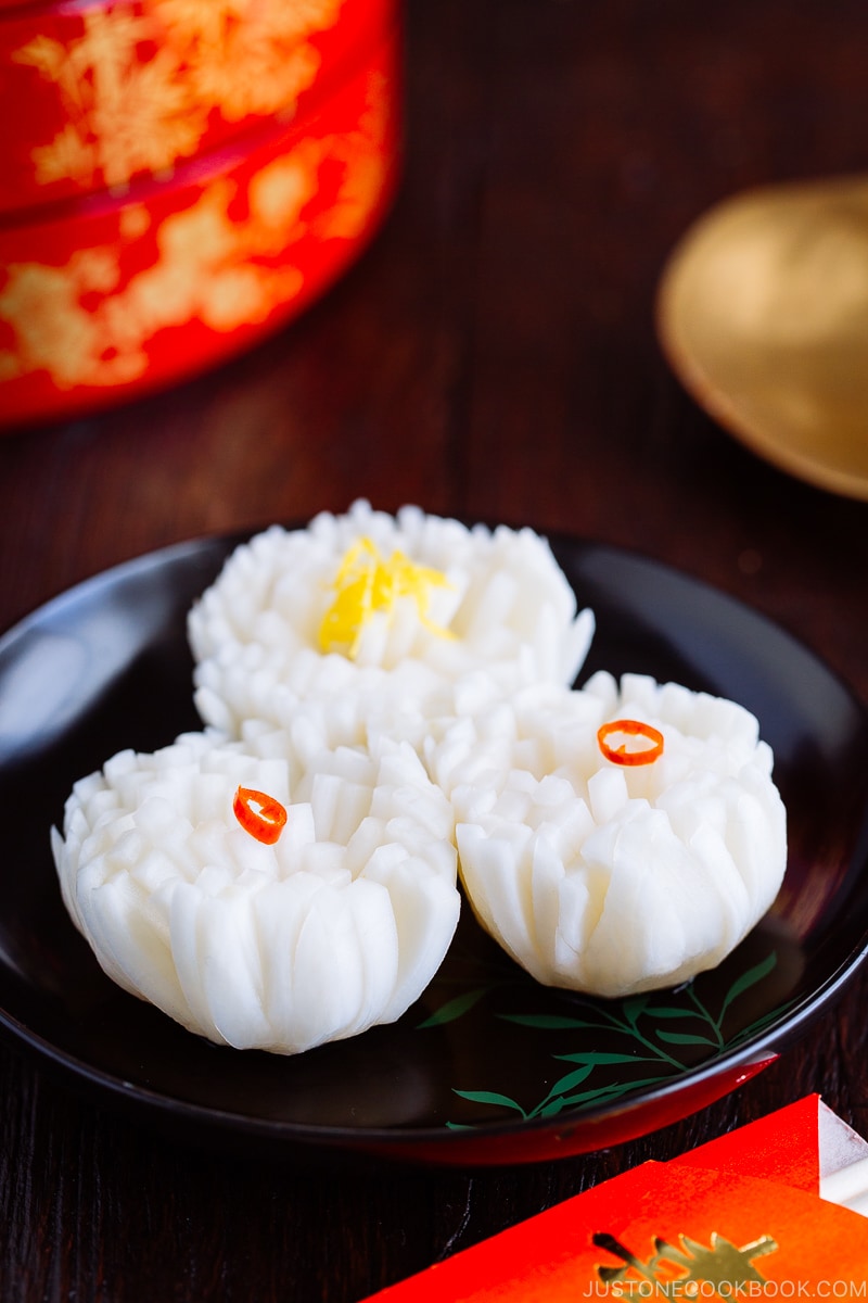 A black lacquered plate containing Pickled Chrysanthemum Turnip (Kikka Kabu).