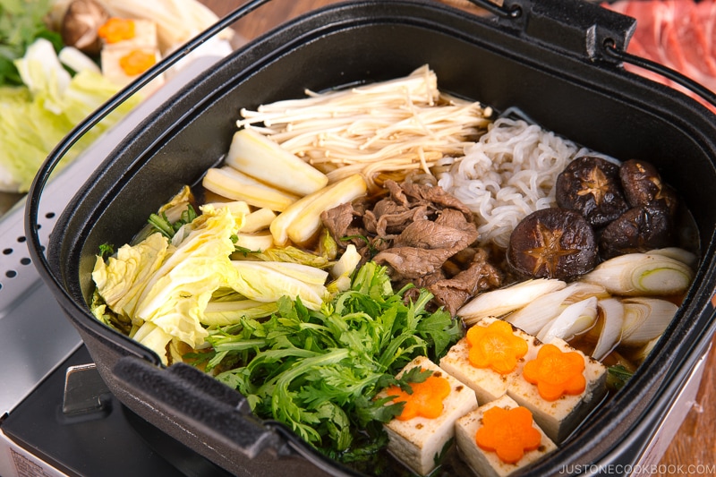 Sukiyaki cooked in a cast iron pot.