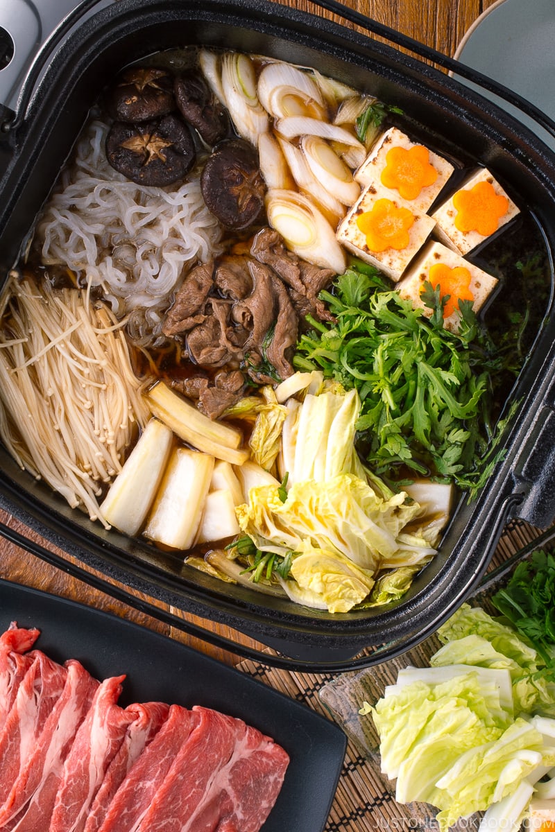 Sukiyaki cooked in a cast iron pot.