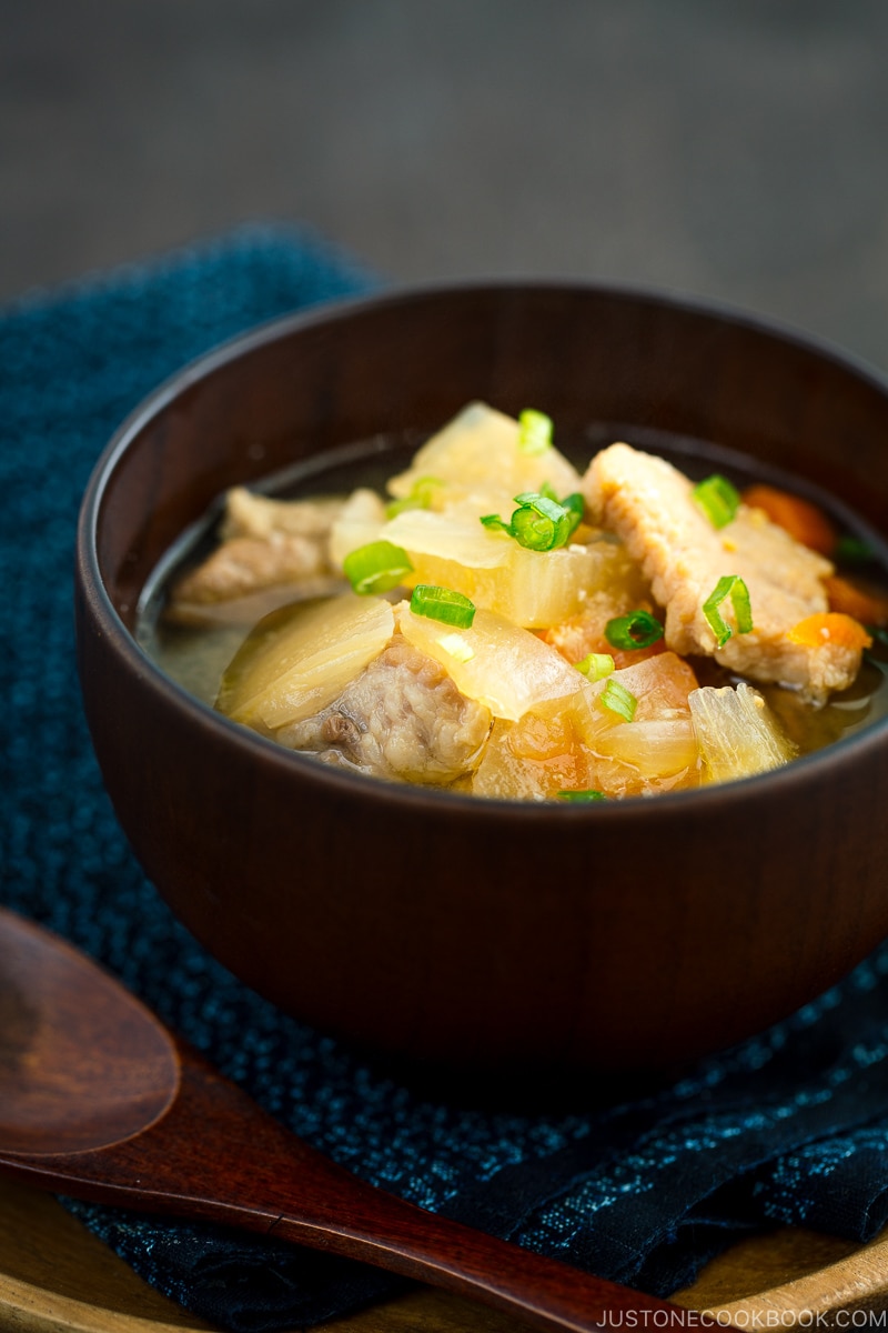 Pork and vegetable miso soup in a wooden bowl.