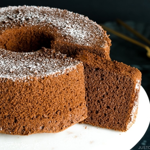 A chocolate chiffon cake served on a cake stand.