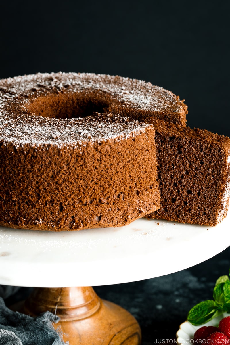 A chocolate chiffon cake served on a cake stand.