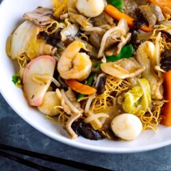 A white bowl containing Crispy Noodles with Seafood (Sara Udon).
