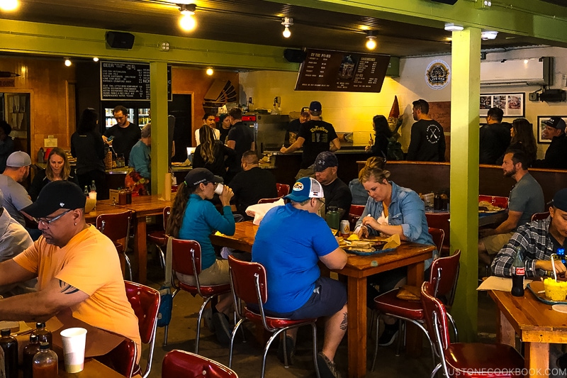 customers eating and waiting in line at Franklin Barbecue in Austin TX