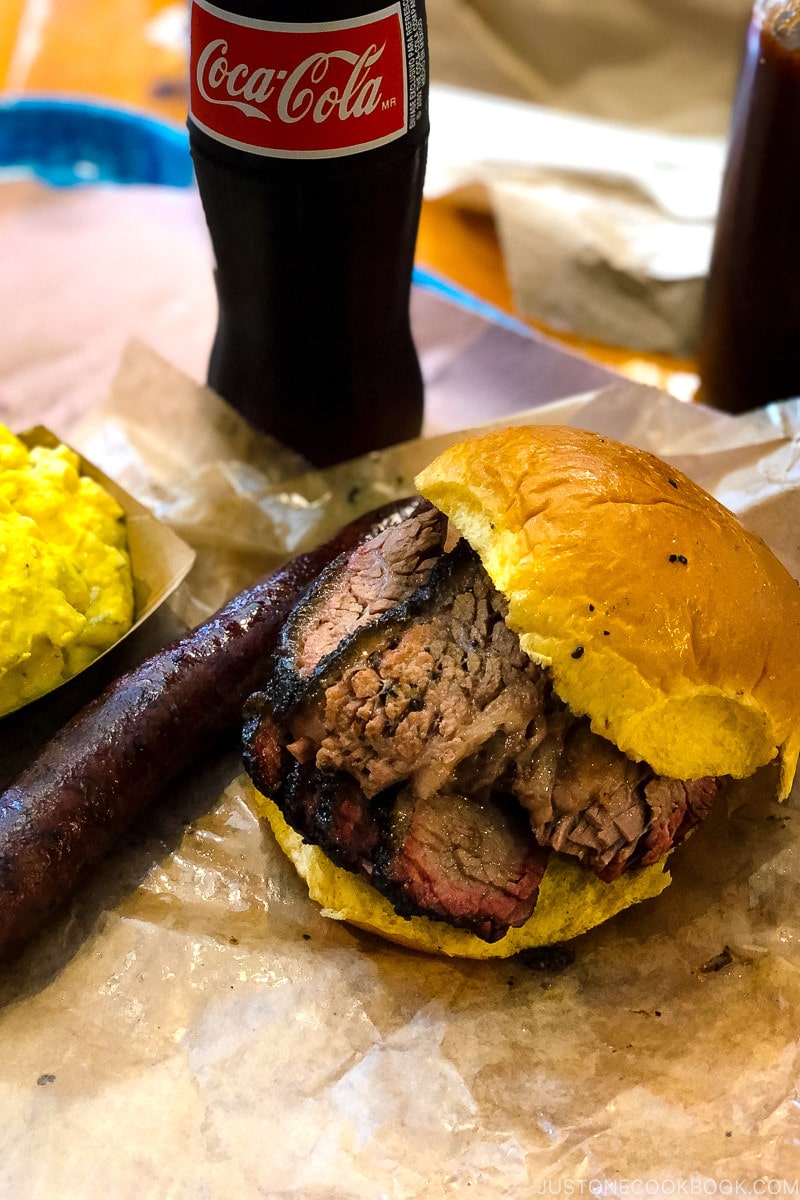 Beef brisket sandwich with sausage and potato salad at Franklin Barbecue in Austin TX