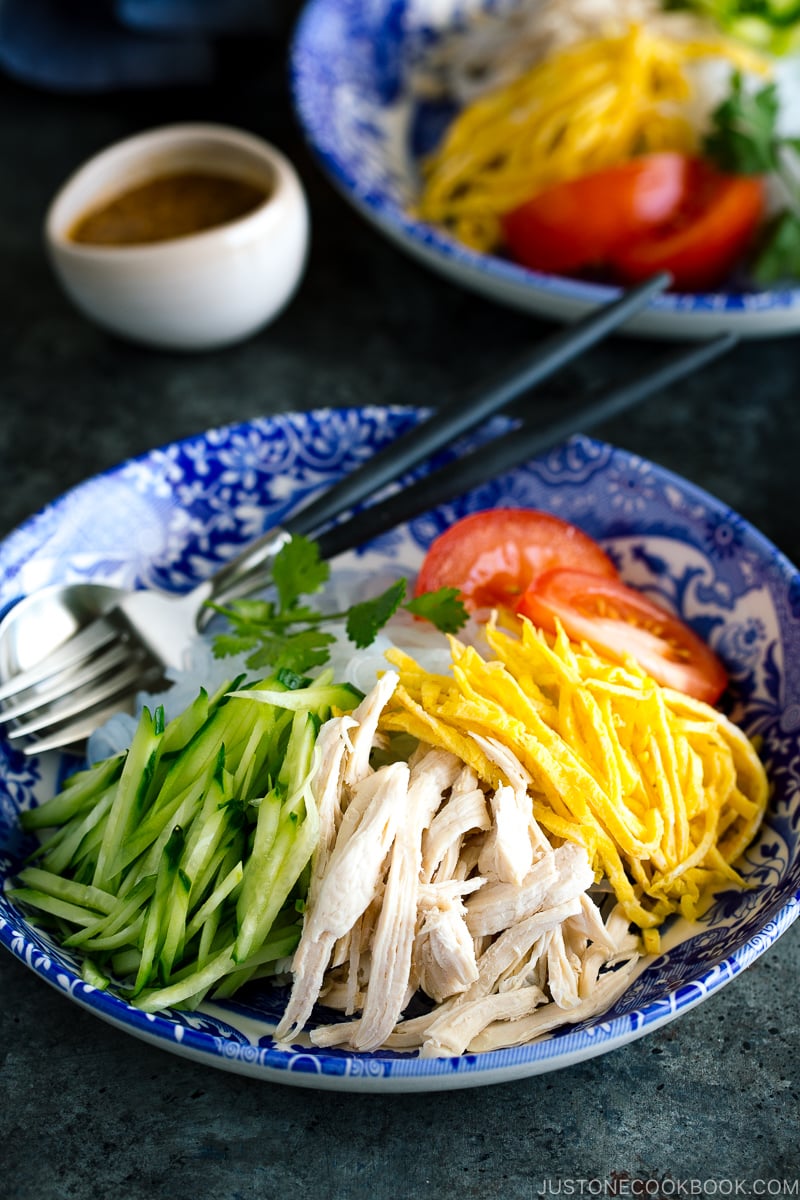 A blue bowl containing cold and refreshing shirataki noodles with honey sesame dressing.