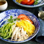 A blue bowl containing cold and refreshing shirataki noodles with honey sesame dressing.