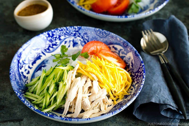 A blue bowl containing cold and refreshing shirataki noodles with honey sesame dressing.