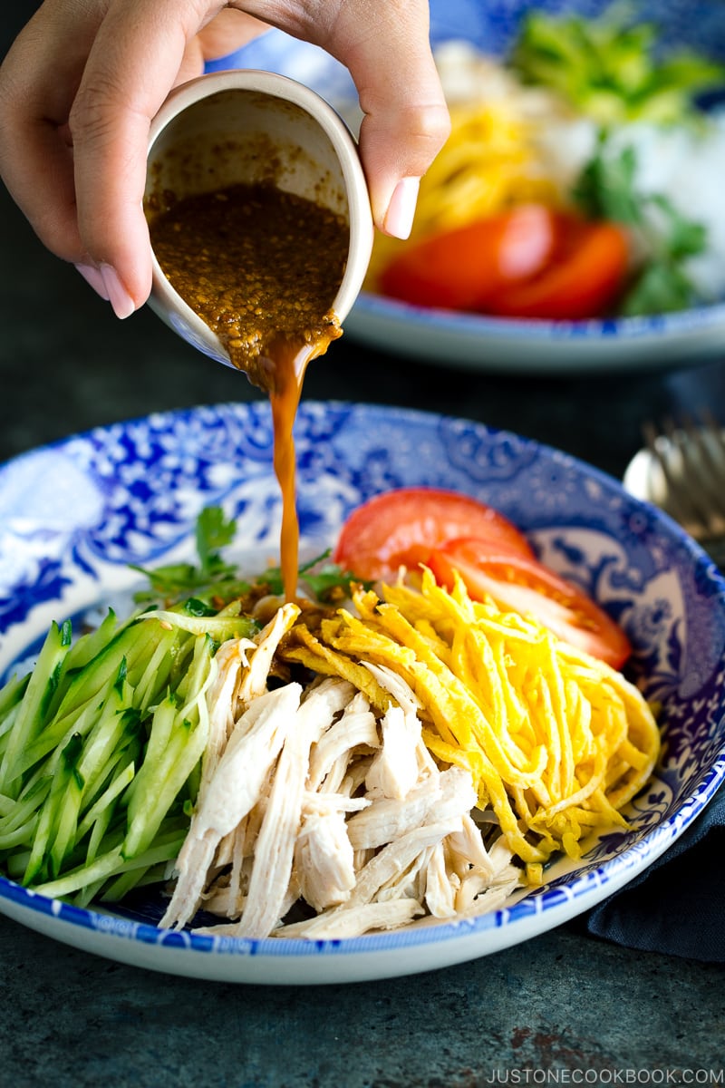 A blue bowl containing cold and refreshing shirataki noodles with honey sesame dressing.