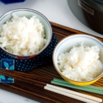 Japanese rice bowls containing perfectly cooked Japanese rice.