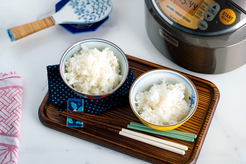 Japanese rice bowls containing perfectly cooked Japanese rice.
