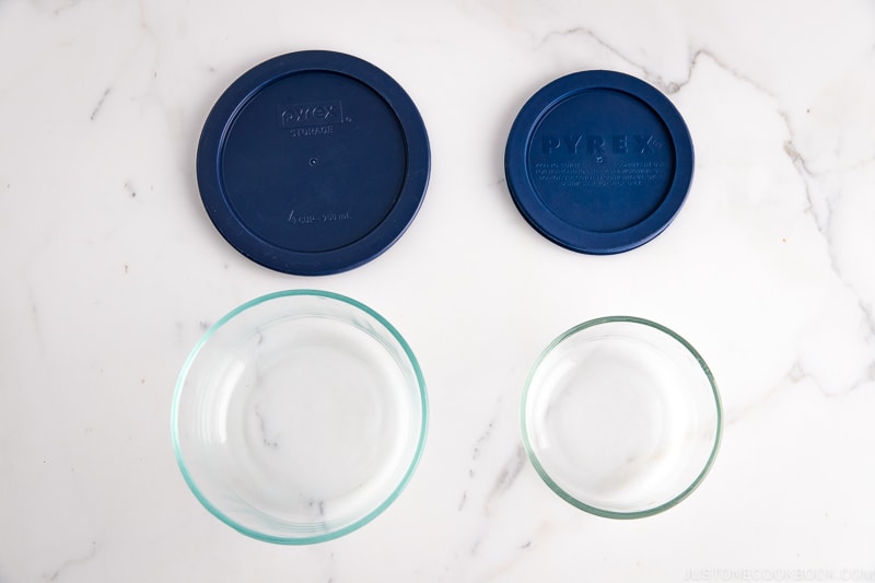 Pyrex glass containers with lids.