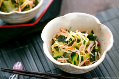 A flower shape bowl containing Japanese Cucumber Salad with Crab.