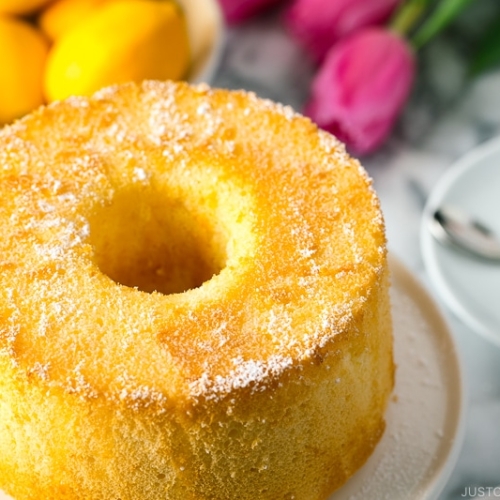 Meyer Lemon Chiffon Cake on a white cake stand.