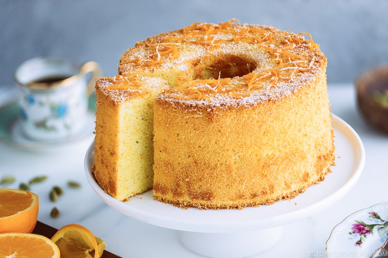 Orange chiffon cake served on a cake stand.