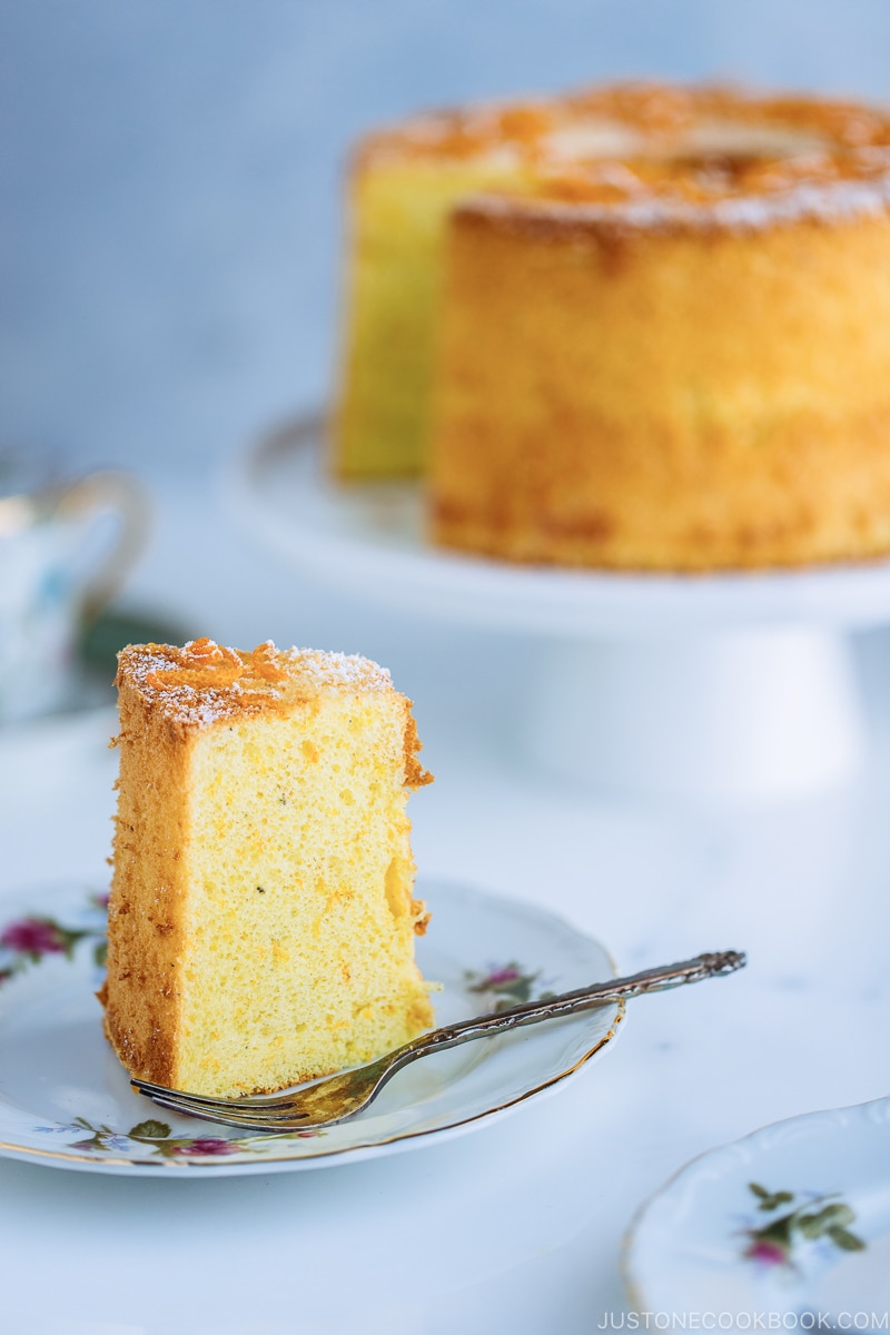 Orange chiffon cake slice on a plate.