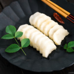 A black plate containing pickled daikon with shio koji.