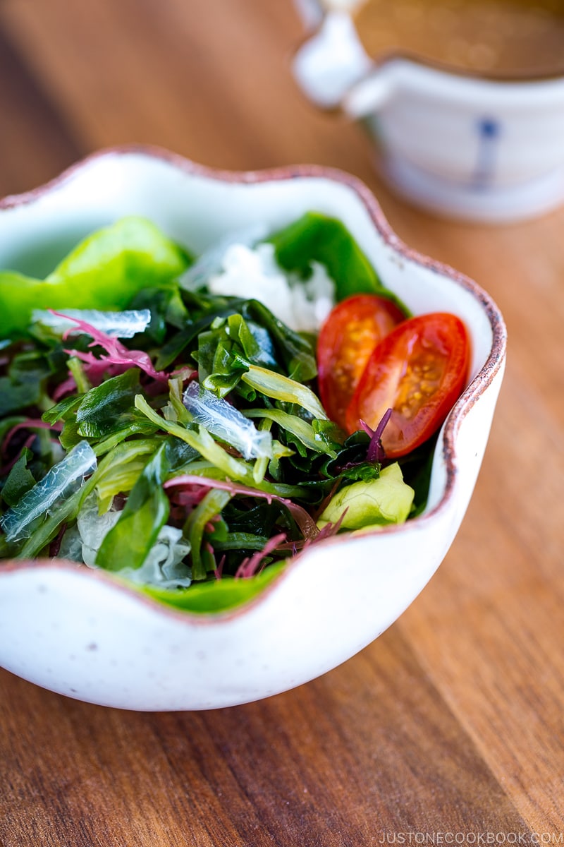 A white ceramic bowl containing seaweed salad.