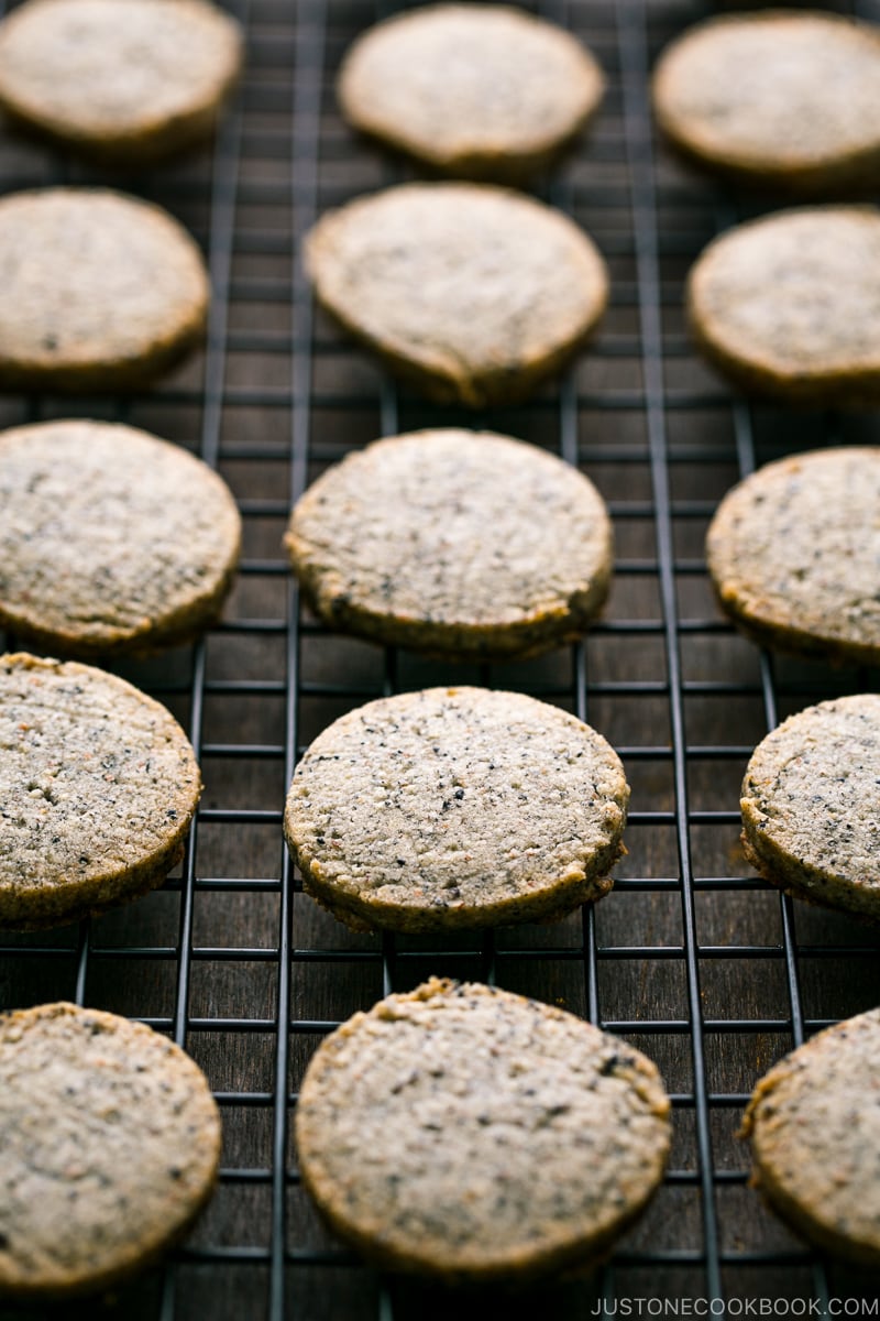 Black sesame cookies lay on the wire rack.