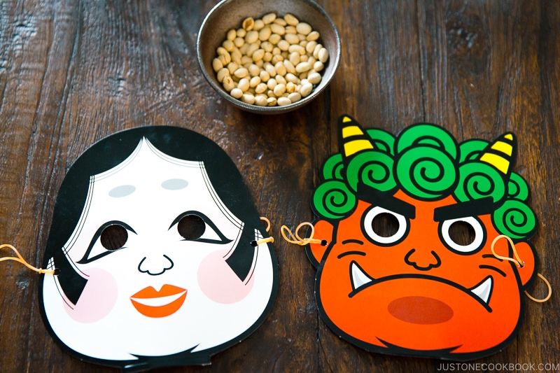a bowl with beans and two masks below it