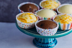 3 types of steamed cakes on a cake stand.