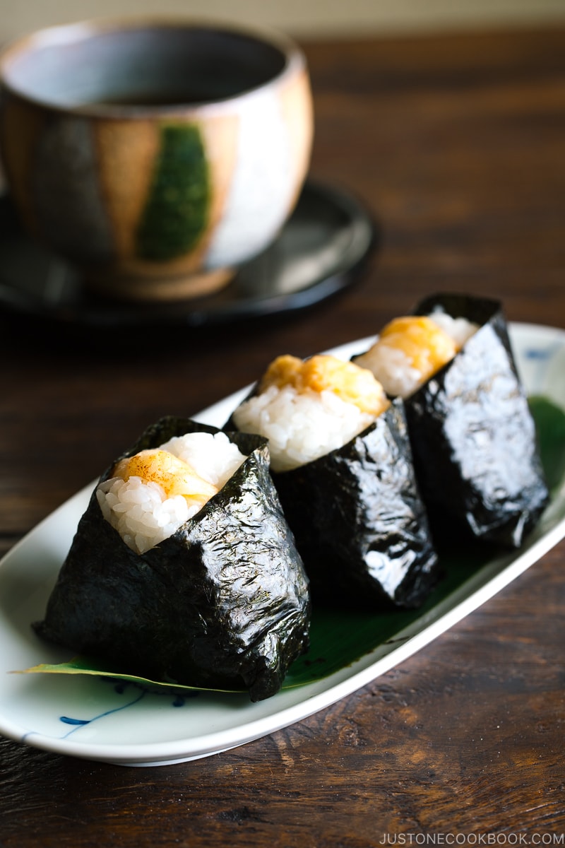 Tenmusu (Shrimp Tempura Rice Balls) on a long Japanese plate.