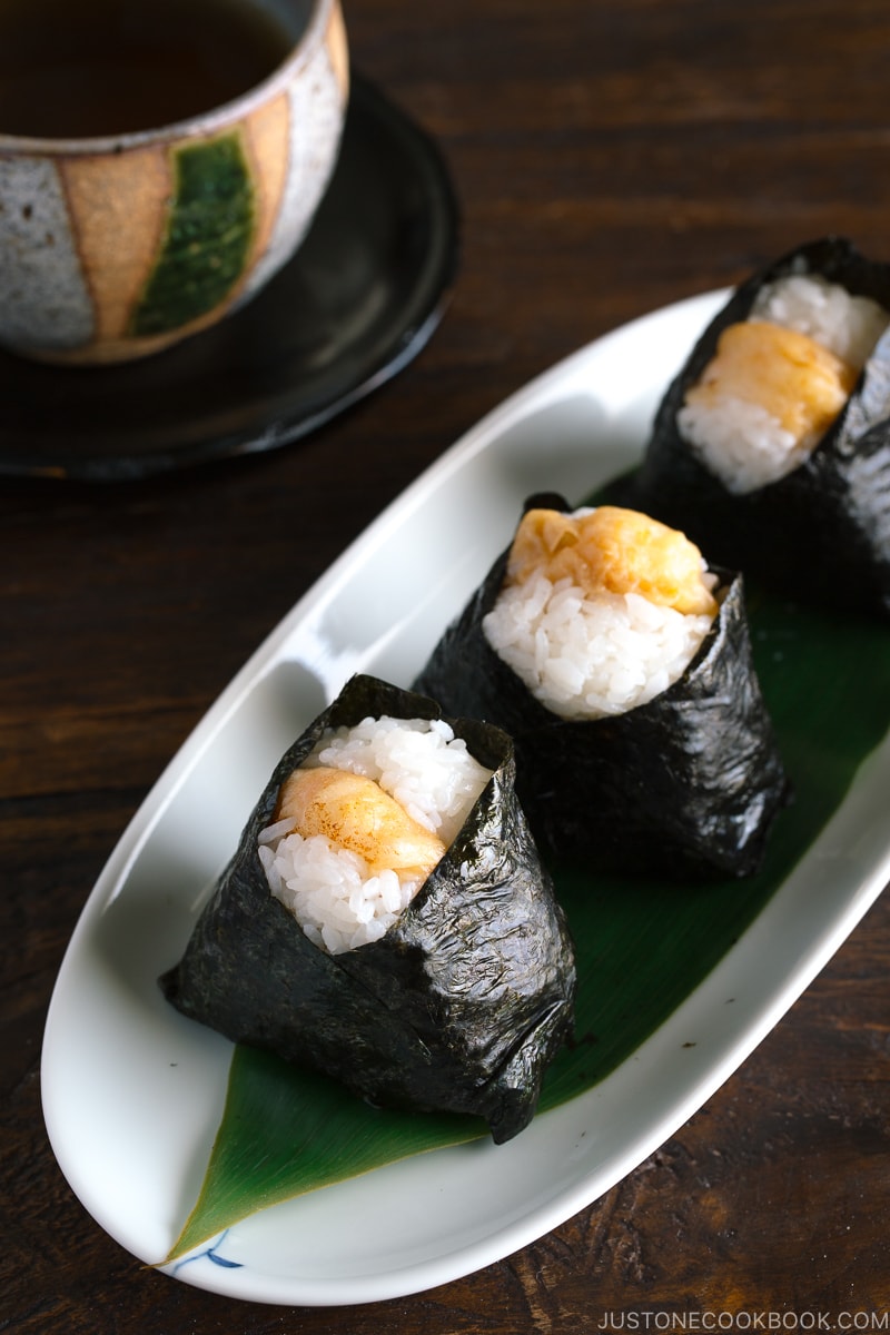 Tenmusu (Shrimp Tempura Rice Balls) on a long Japanese plate.