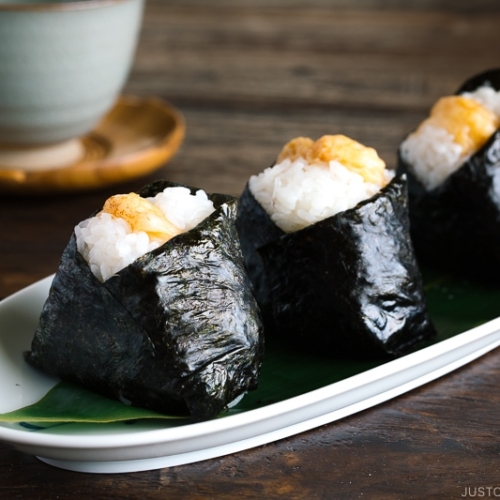 Tenmusu (Shrimp Tempura Rice Balls) on a long Japanese plate.