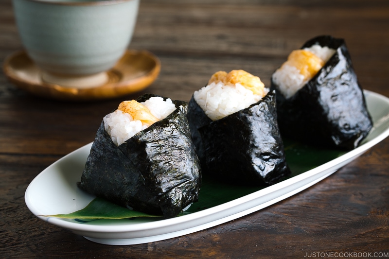 Tenmusu (Shrimp Tempura Rice Balls) on a long Japanese plate.