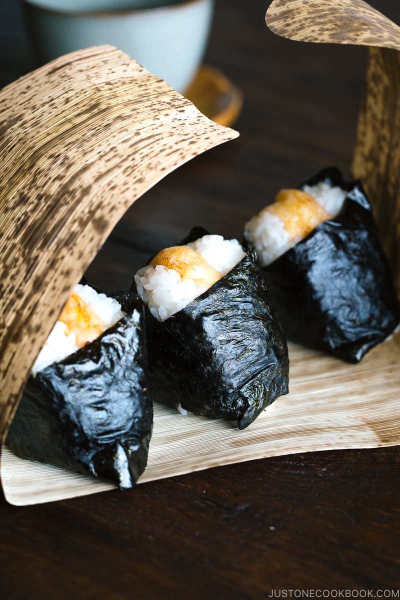 Tenmusu (Shrimp Tempura Rice Balls) on a bamboo wrap.