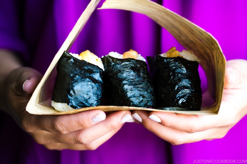 Tenmusu (Shrimp Tempura Rice Balls) on a bamboo wrap.