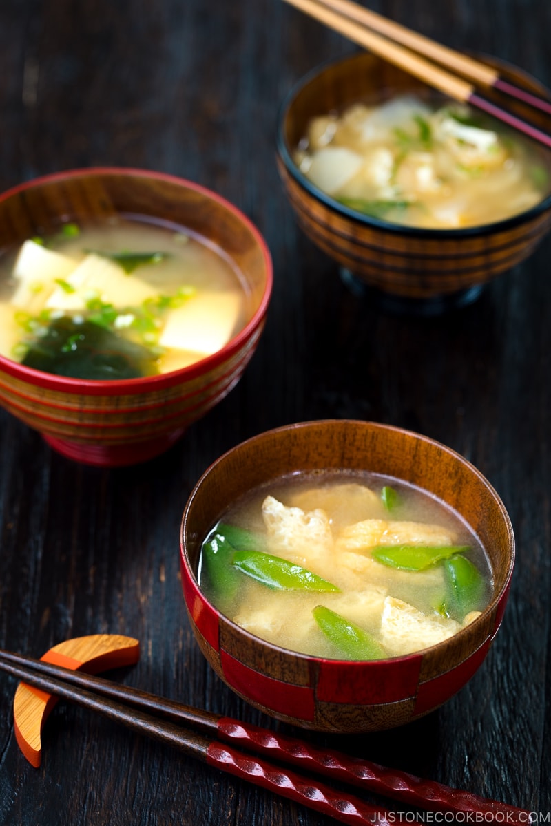 Three kinds of vegetable miso soups; each served in a Japanese wooden bowl.