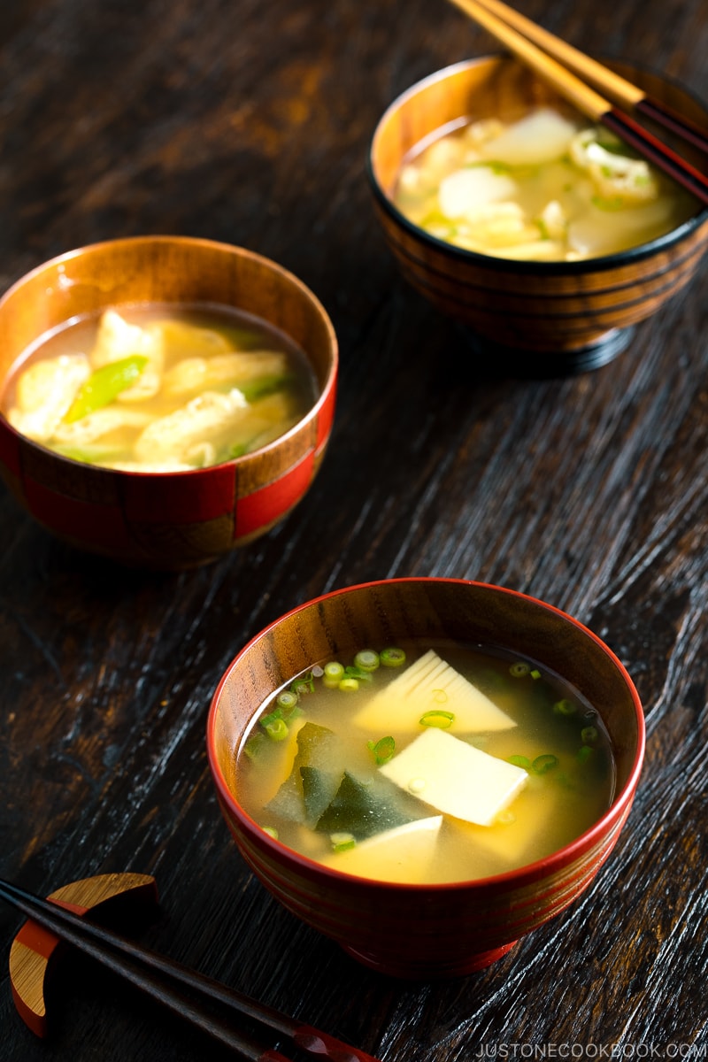 Three kinds of vegetable miso soups; each served in a Japanese wooden bowl.
