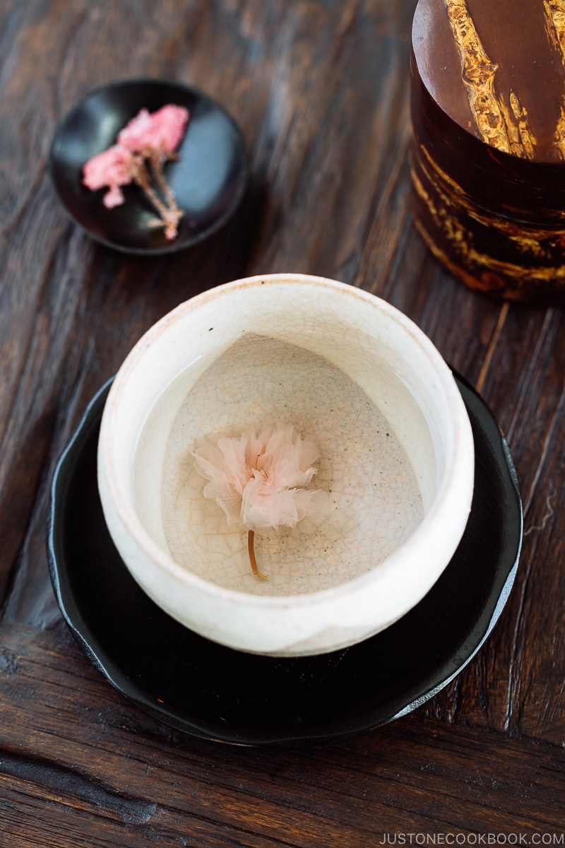Cherry blossom tea in a white tea cup.
