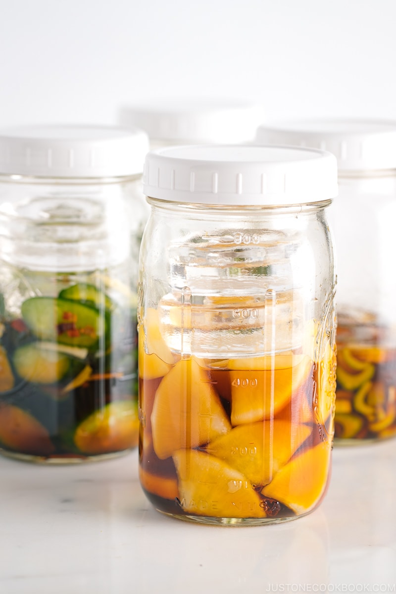 4 Mason jars, each filled with a different soy sauce pickles.