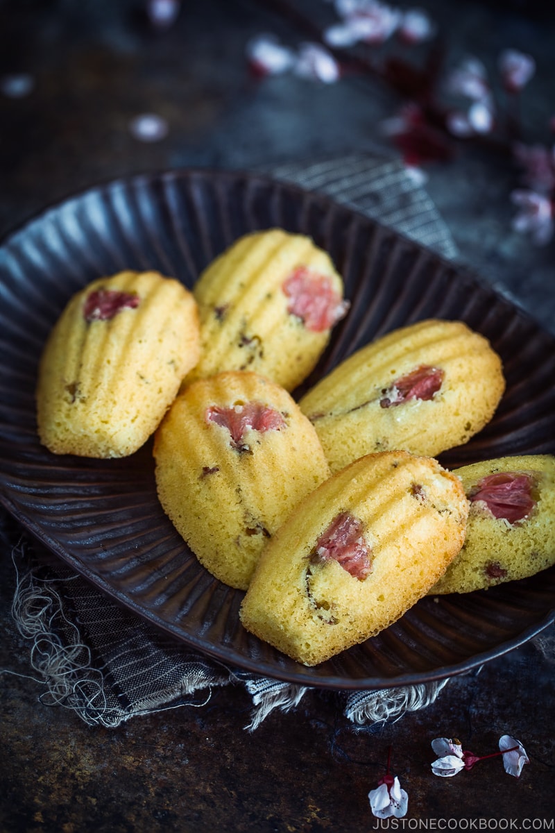 Cherry Blossom Madeleines on a black platter.