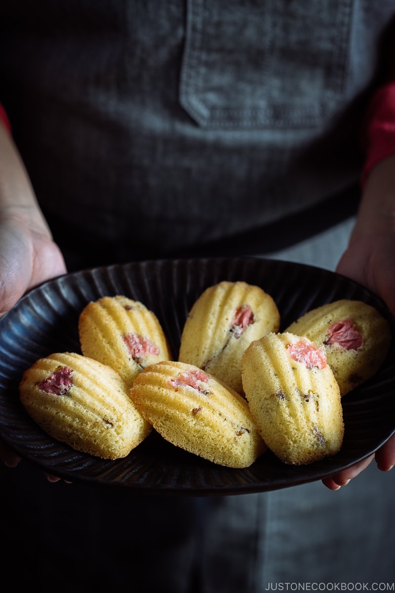 Cherry Blossom Madeleines on a black platter.