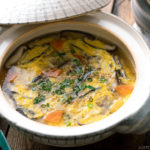 Chicken Zosui (Japanese rice soup) served in a donabe, Japanese earthenware pot.