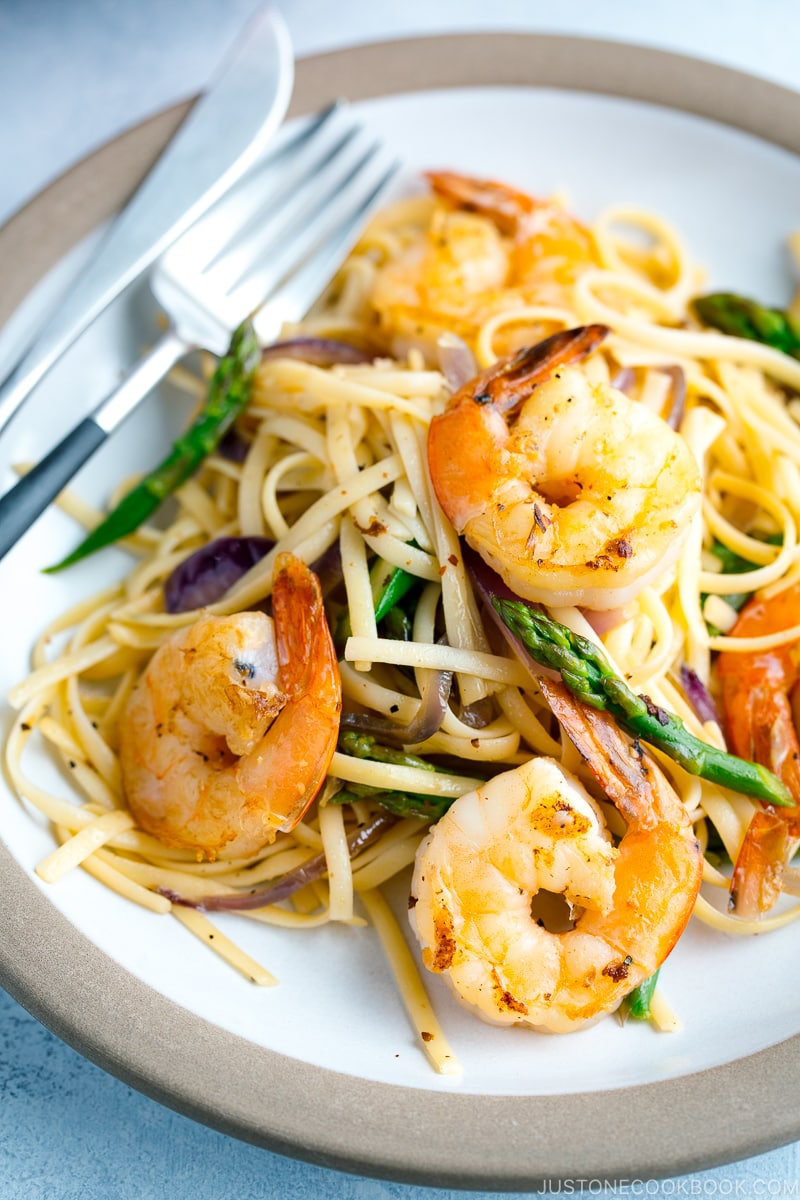 A plate containing Japanese-style Pasta with Shrimp and Asparagus.