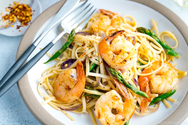 A plate containing Japanese-style Pasta with Shrimp and Asparagus.