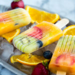 Homemade fruit popsicles on ice cubes.