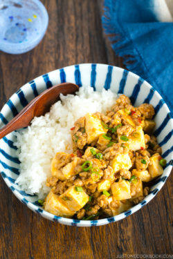 A Japanese blue and white bowl containing Mapo Tofu over steamed rice.
